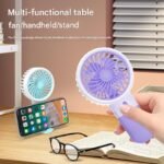 Portable Mini Fan being used as a handheld fan for travel and outdoor cooling